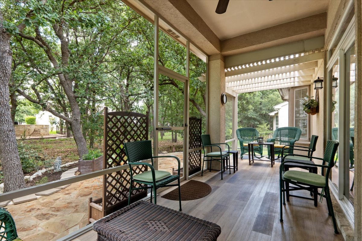 503 Breezeway Lane Georgetown, TX 78633 - Photo 32 of 38 Screened-in porch with luxury vinyl plank flooring, offering a comfortable space to relax and enjoy the outdoors year-round.