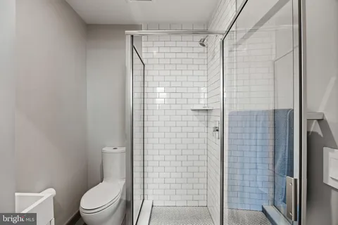 a bathroom with a toilet and shower