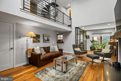 a living room with furniture a rug and a chandelier
