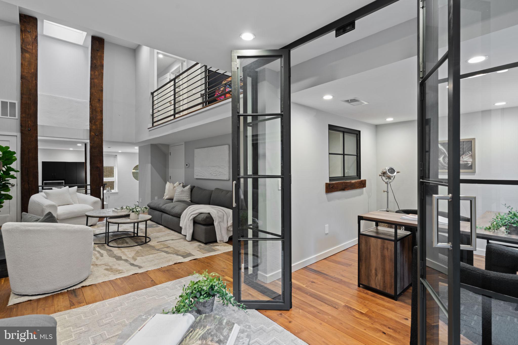 2030 Ranstead Street Philadelphia, PA 19103 - Photo 17 of 49 a living room with furniture a wooden floor and a large window