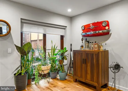 a dining room with furniture and potted plant