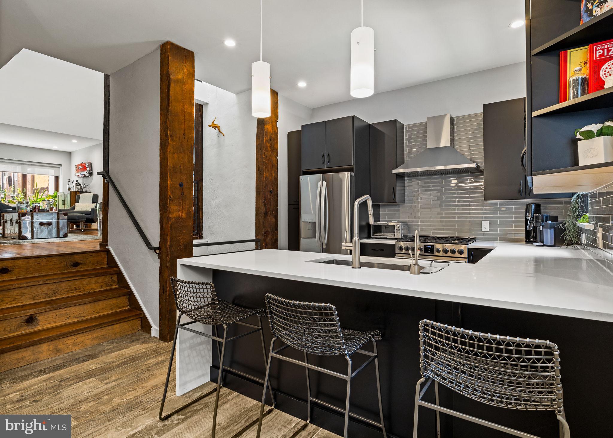 2030 Ranstead Street Philadelphia, PA 19103 - Photo 22 of 49 a kitchen with stainless steel appliances a sink cabinets and wooden floor