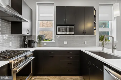 a kitchen with a sink stove and microwave
