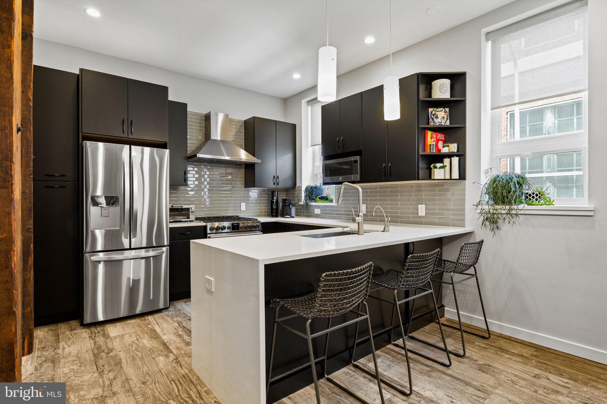 2030 Ranstead Street Philadelphia, PA 19103 - Photo 28 of 49 a kitchen with stainless steel appliances granite countertop a refrigerator and a stove top oven