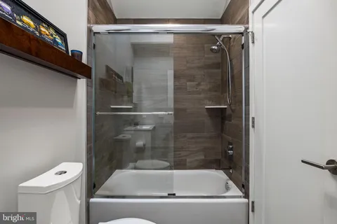 a bathroom with a tub and toilet