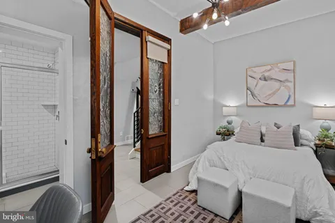 a bedroom with a bed and a mirror