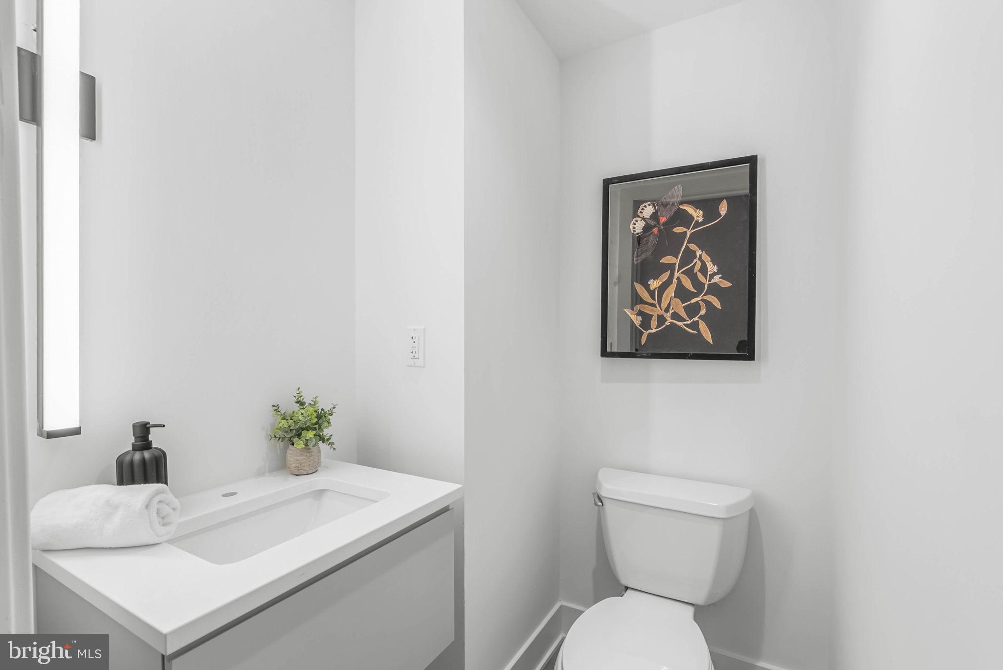 635 North 7th Street, Unit H2A Philadelphia, PA 19123 - Photo 19 of 25 a white toilet sitting next to a bathroom sink