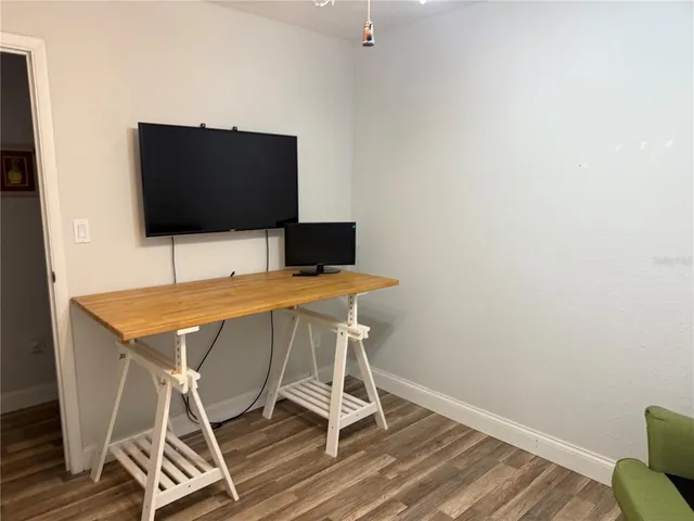 a living room with a flat screen tv and outdoor view