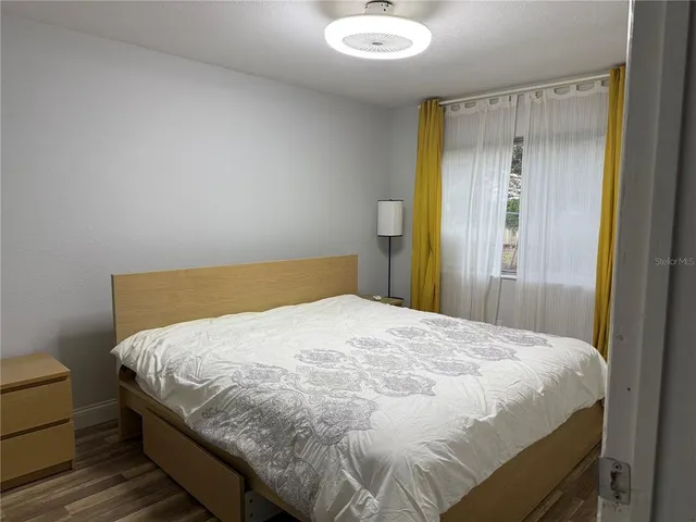 a large bed sitting in a bedroom next to a bathroom sink