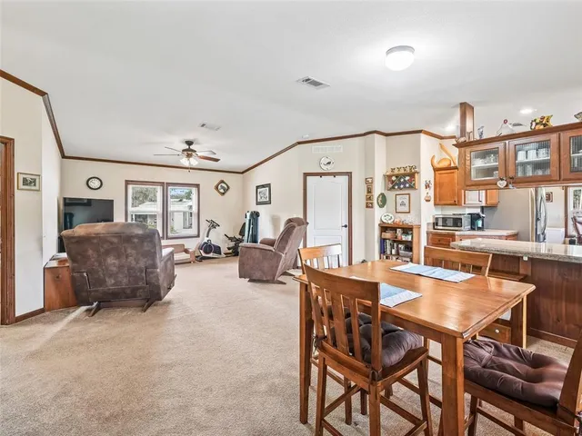 a room with stainless steel appliances kitchen island granite countertop furniture and a large window