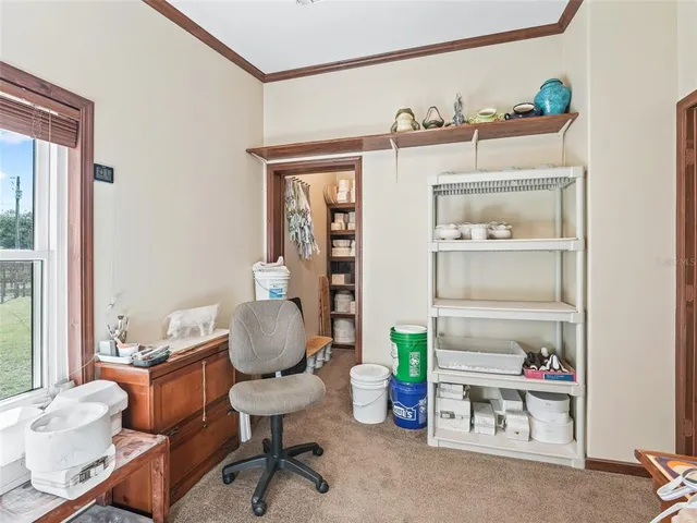 a view of a workspace with furniture and a bookshelf