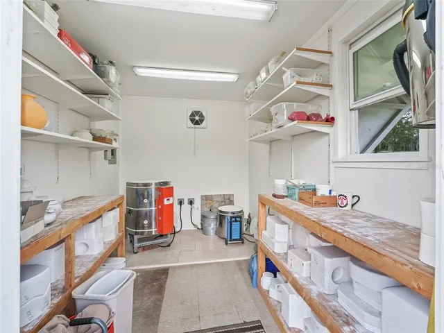 an aerial view of a residential houses with a lush green forest