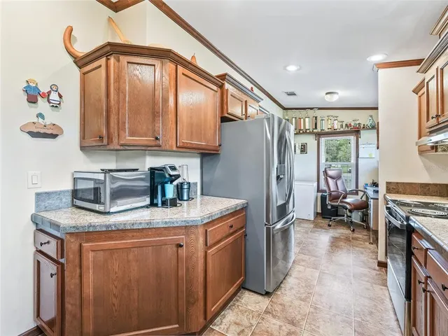 a kitchen with kitchen island granite countertop a sink counter top space and appliances