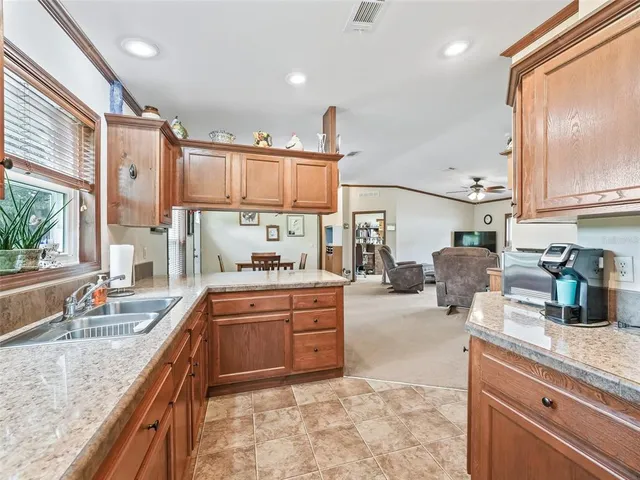 a kitchen with stainless steel appliances granite countertop a refrigerator and a stove top oven
