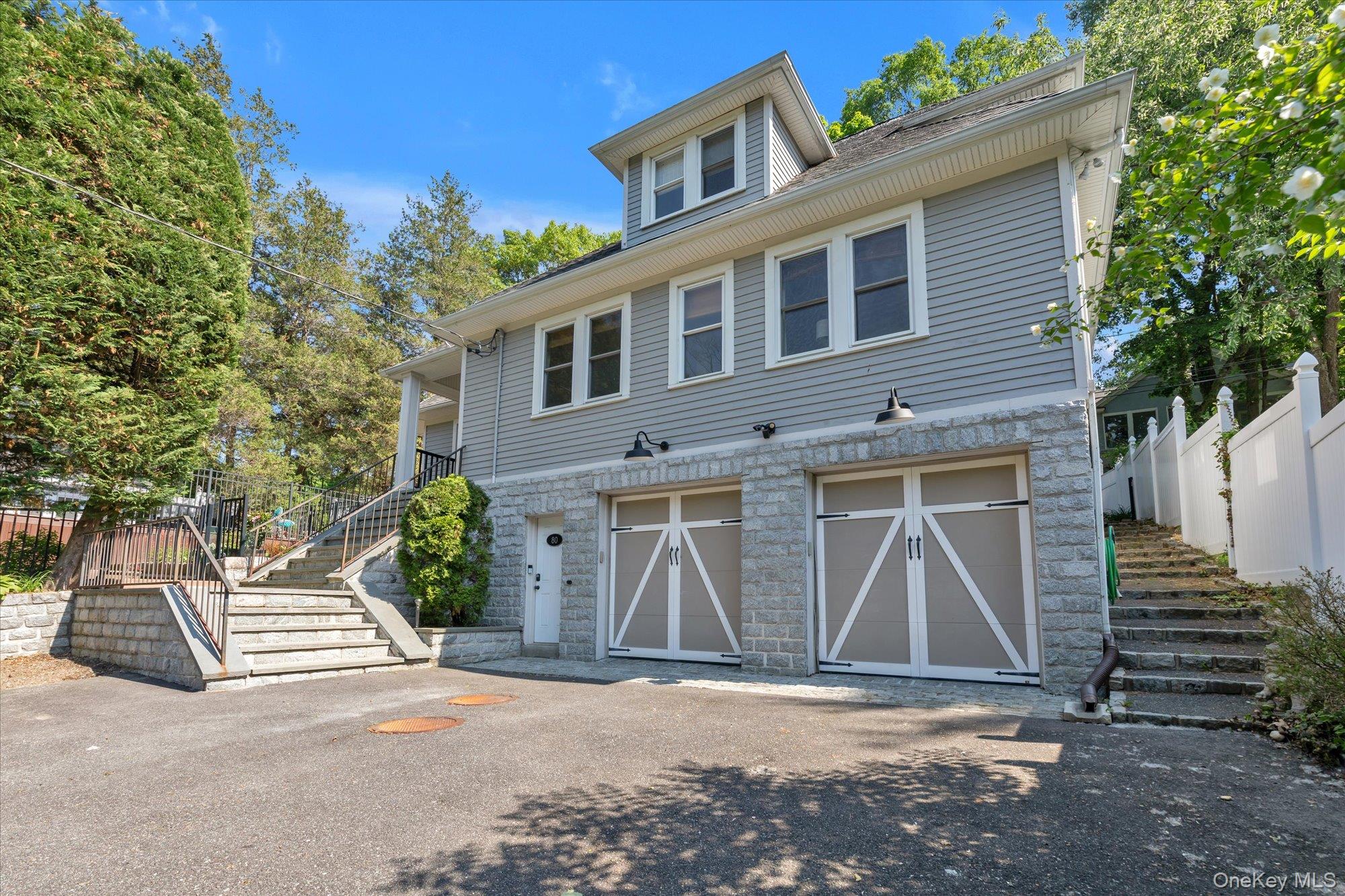 80 Skunks Misery Road Locust Valley, NY 11560 - Photo 3 of 25 a front view of a house with garage
