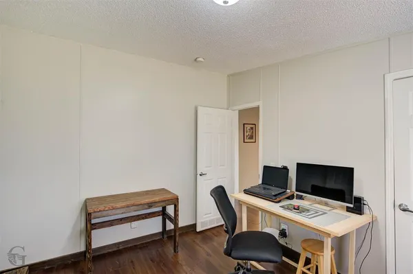 a workspace with furniture and wooden floor