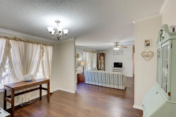 a view of a room with wooden floor and windows
