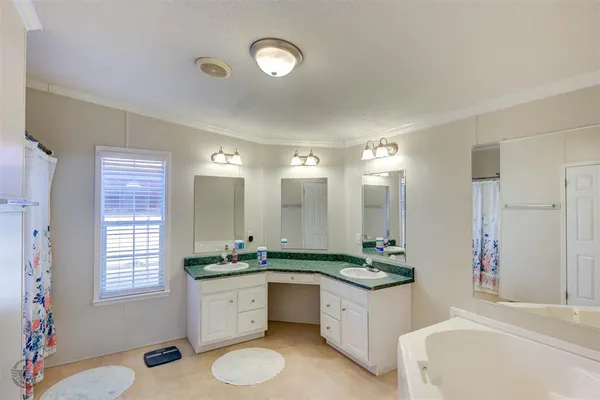 a bathroom with a granite countertop sink mirror bathtub and shower