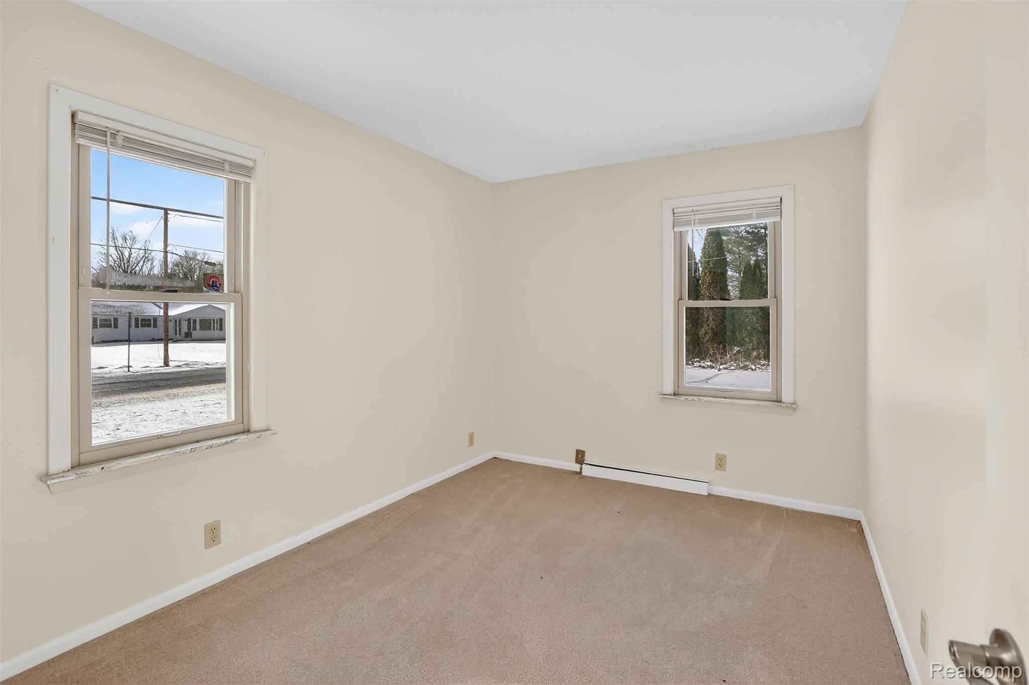 3241 Curtis Road Birch Run, MI 48415 - Photo 28 of 47 Carpeted spare room featuring baseboards and a baseboard heating unit