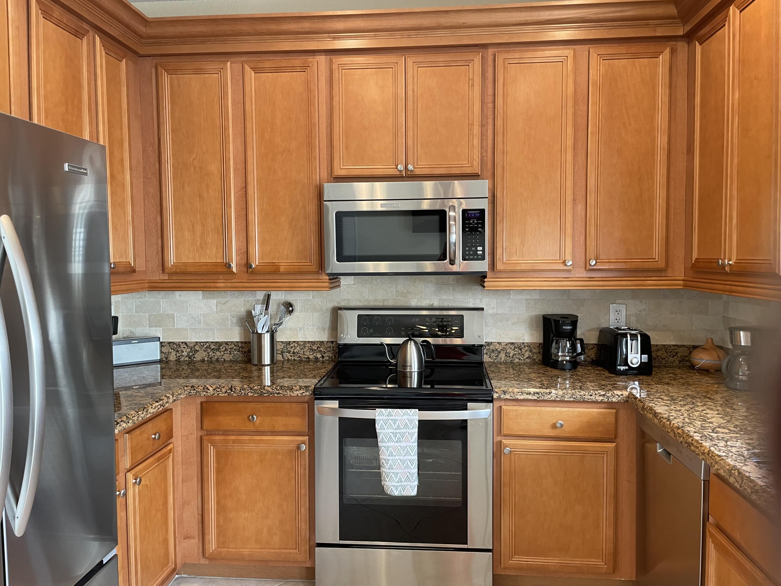 1157 Northwest 18th Avenue Boca Raton, FL 33431 - Photo 11 of 22 a kitchen with stainless steel appliances granite countertop a refrigerator a stove a sink and a microwave
