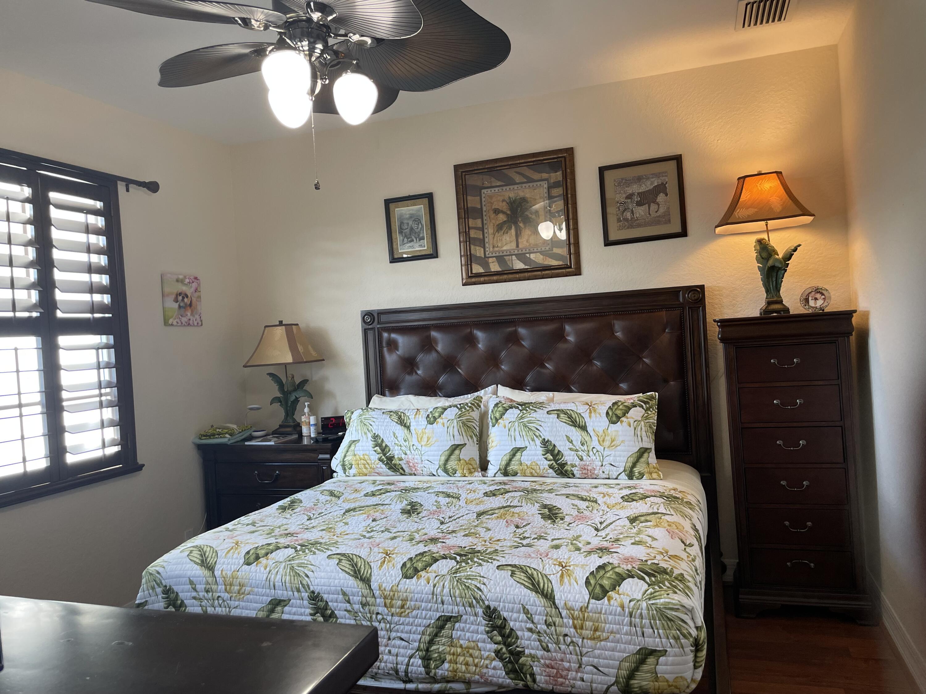 1157 Northwest 18th Avenue Boca Raton, FL 33431 - Photo 14 of 22 a bedroom with a bed and wooden floor