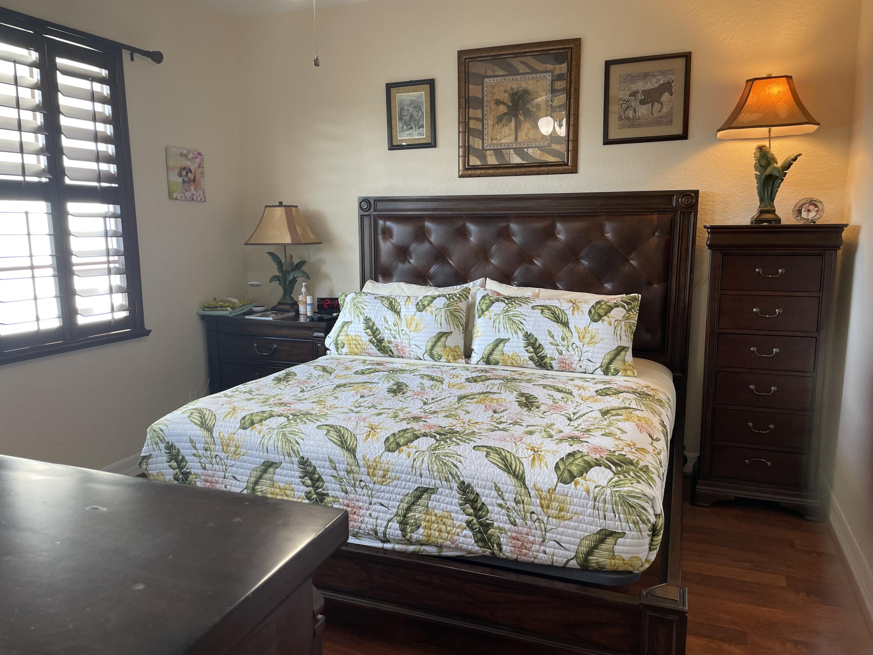 1157 Northwest 18th Avenue Boca Raton, FL 33431 - Photo 15 of 22 a bed sitting in a bedroom next to a window