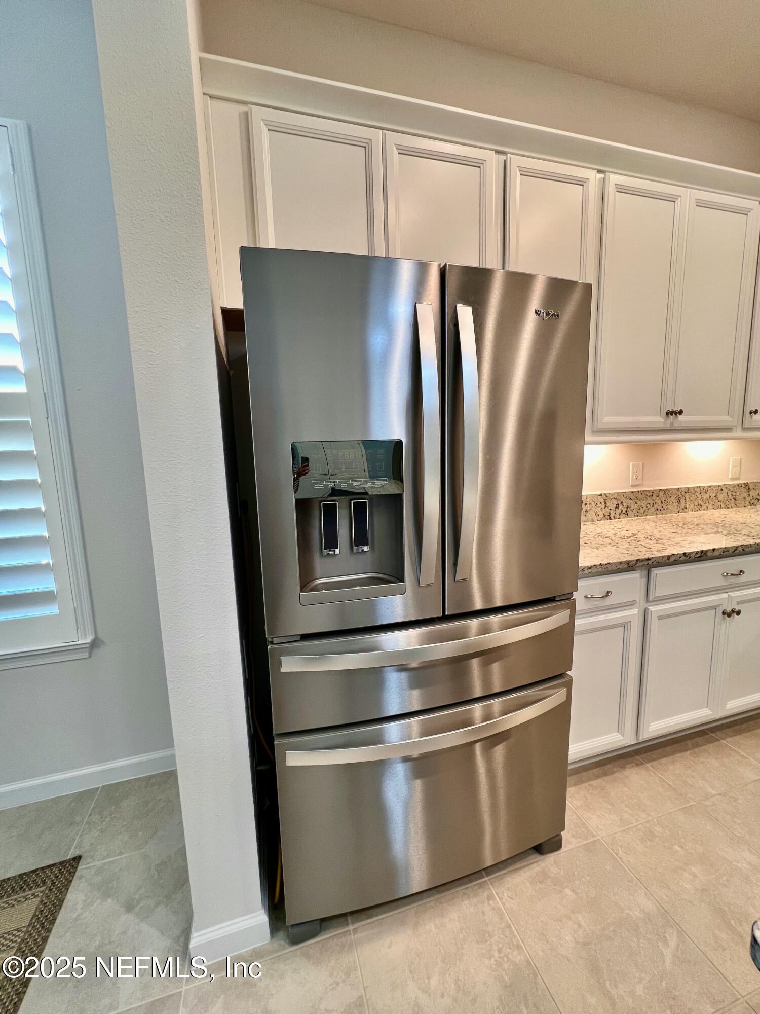 3274 Bailey Ann Drive Ormond Beach, FL 32174 - Photo 11 of 46 a metallic refrigerator freezer sitting in a kitchen