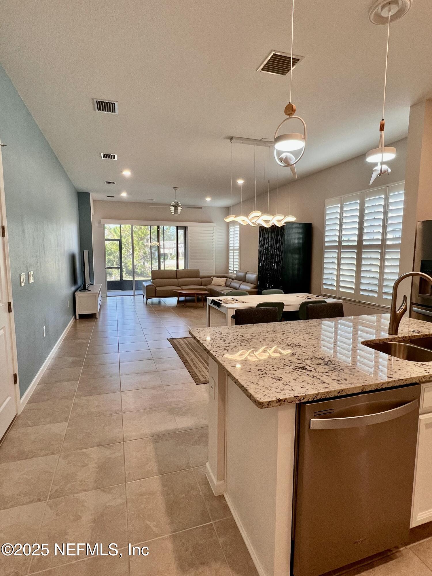 3274 Bailey Ann Drive Ormond Beach, FL 32174 - Photo 13 of 46 a large kitchen with stainless steel appliances granite countertop a large counter top a sink a stove a dining table and chairs