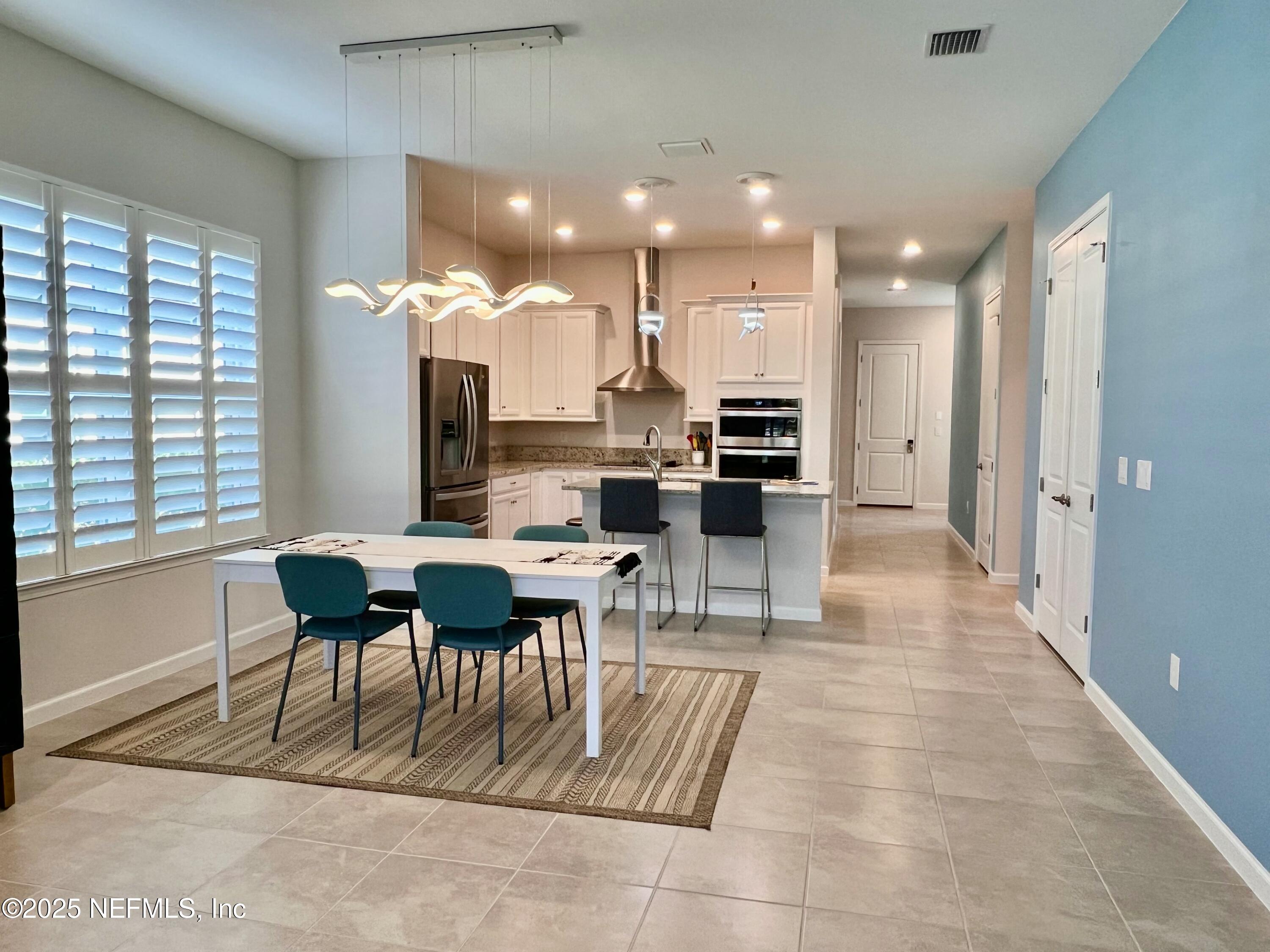 3274 Bailey Ann Drive Ormond Beach, FL 32174 - Photo 16 of 46 a view of a dining room with furniture