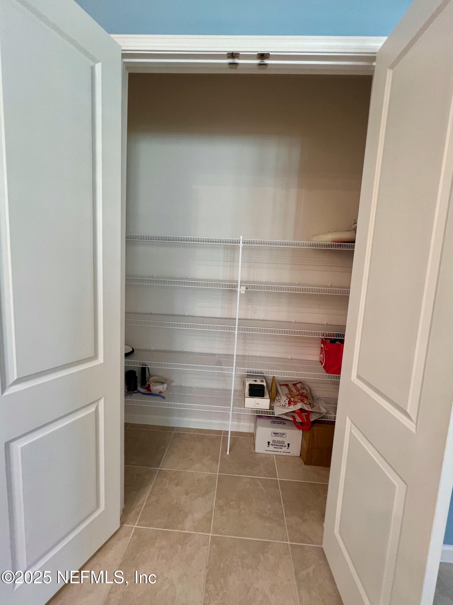 3274 Bailey Ann Drive Ormond Beach, FL 32174 - Photo 18 of 46 a room with a closet and a wooden floor