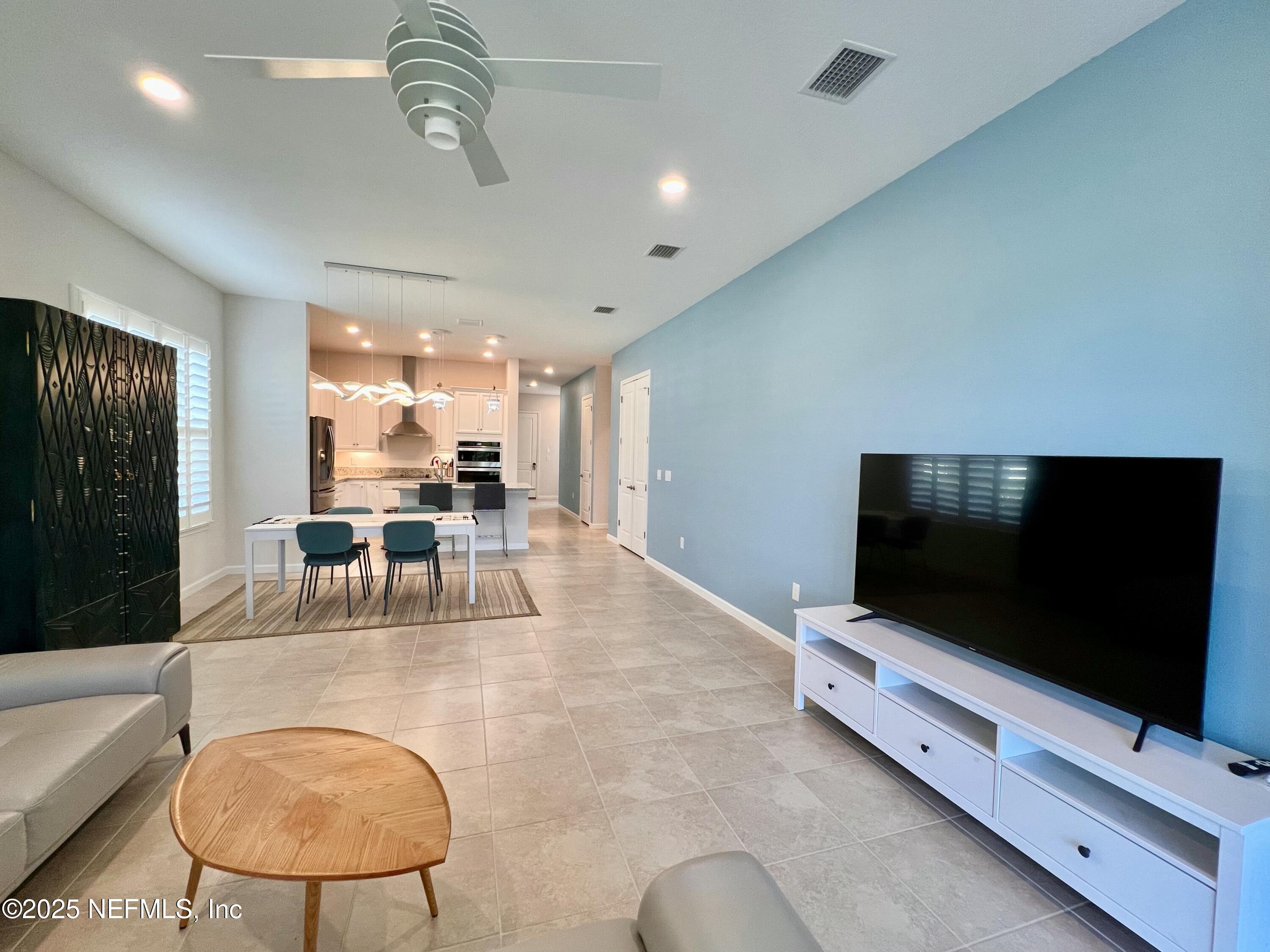 3274 Bailey Ann Drive Ormond Beach, FL 32174 - Photo 19 of 46 a living room with furniture and a flat screen tv