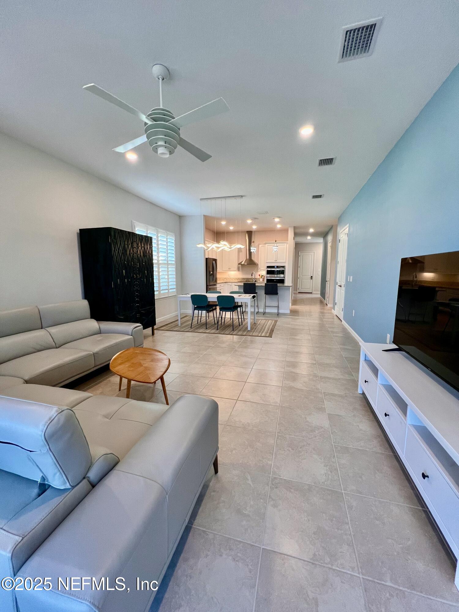 3274 Bailey Ann Drive Ormond Beach, FL 32174 - Photo 20 of 46 a living room with furniture and a flat screen tv