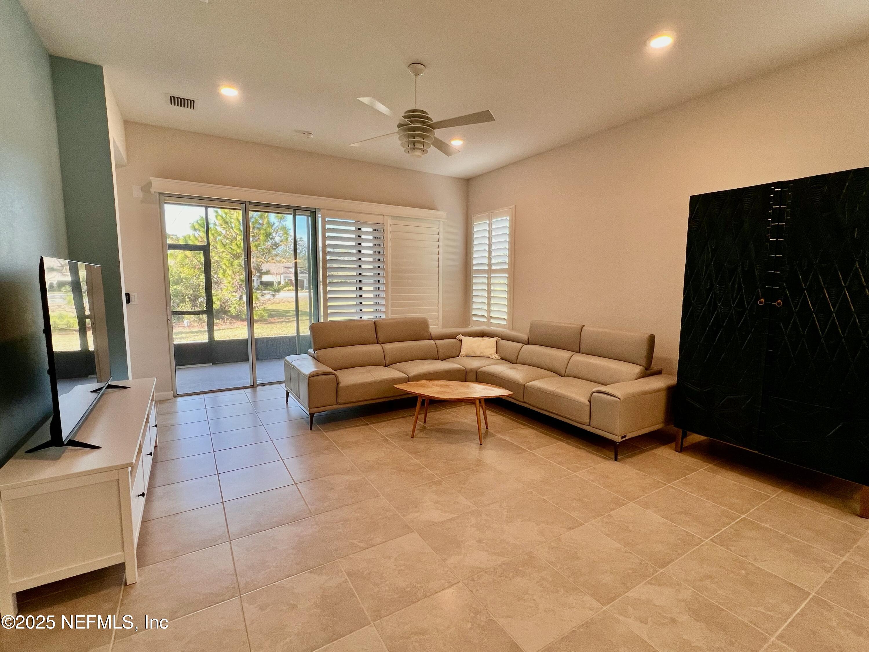 3274 Bailey Ann Drive Ormond Beach, FL 32174 - Photo 21 of 46 a living room with furniture and a flat screen tv