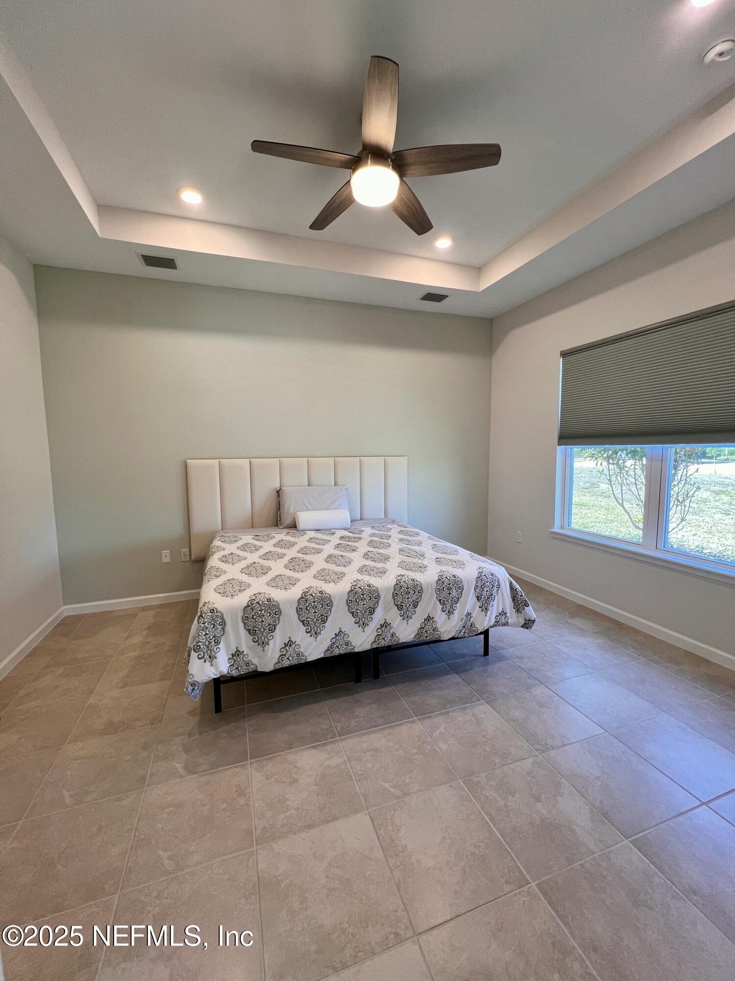 3274 Bailey Ann Drive Ormond Beach, FL 32174 - Photo 28 of 46 a bed sitting in a room next to a window