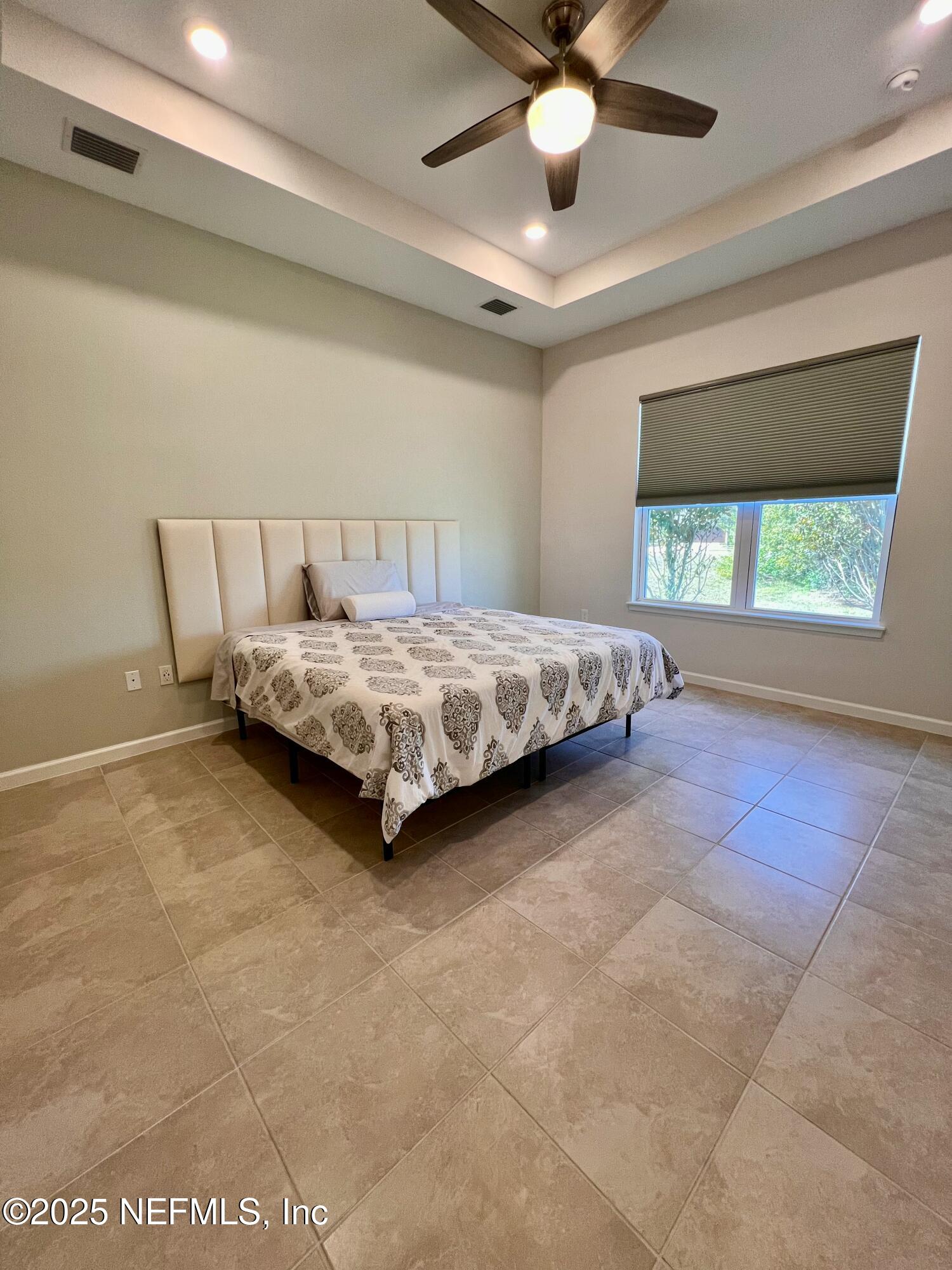 3274 Bailey Ann Drive Ormond Beach, FL 32174 - Photo 29 of 46 a spacious bedroom with a bed and window