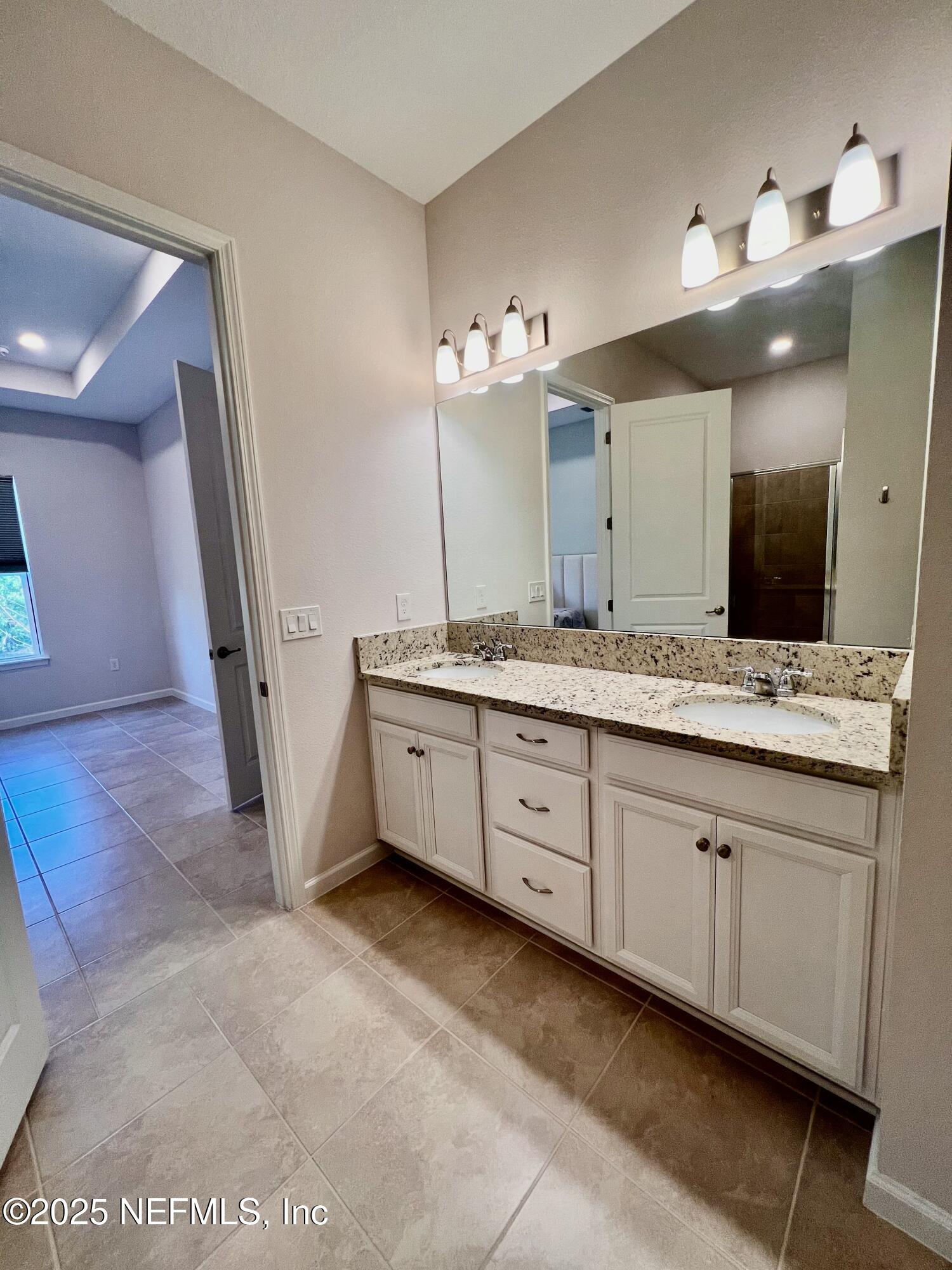 3274 Bailey Ann Drive Ormond Beach, FL 32174 - Photo 30 of 46 a spacious bathroom with a double vanity sink a mirror and a shower