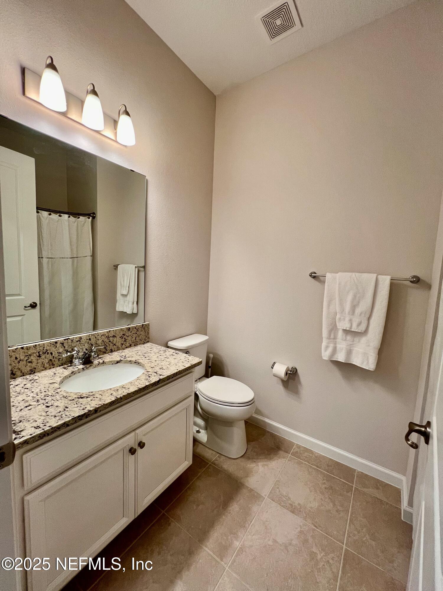 3274 Bailey Ann Drive Ormond Beach, FL 32174 - Photo 31 of 46 a bathroom with a granite countertop sink a toilet and a mirror