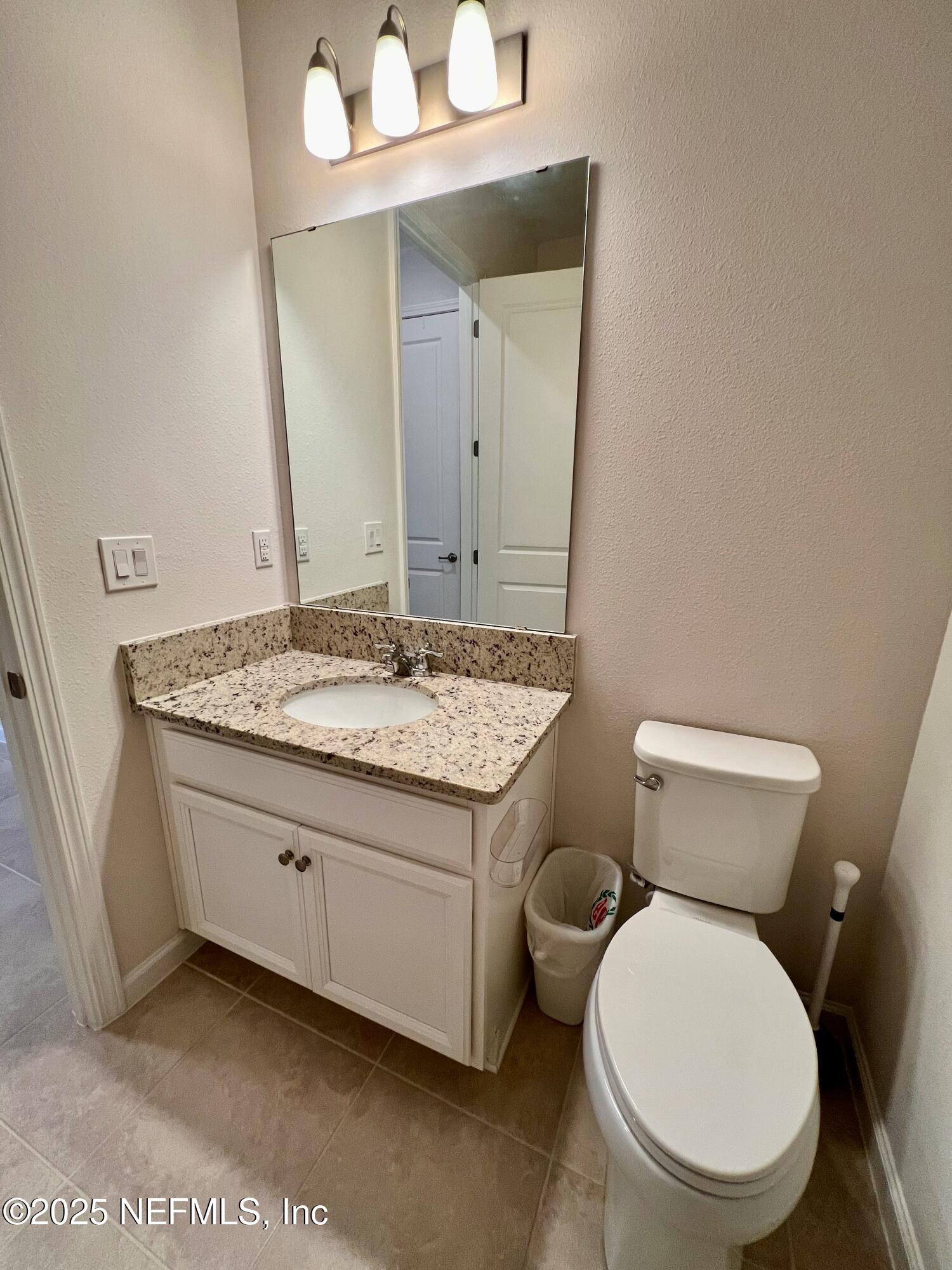 3274 Bailey Ann Drive Ormond Beach, FL 32174 - Photo 37 of 46 a bathroom with a granite countertop toilet sink and mirror
