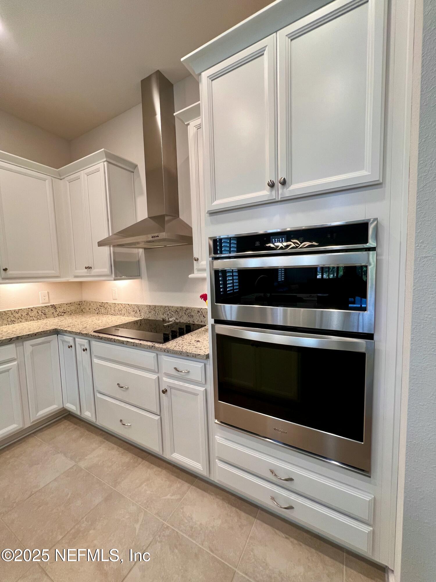 3274 Bailey Ann Drive Ormond Beach, FL 32174 - Photo 8 of 46 a kitchen with granite countertop white cabinets and appliances