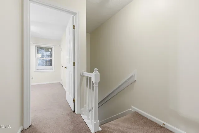 a view of a hallway with a white walls