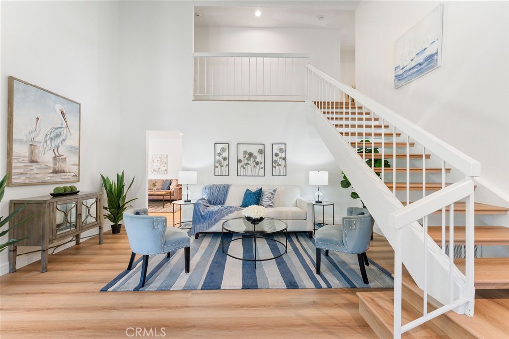 a view of entryway livingroom and hall with wooden floor