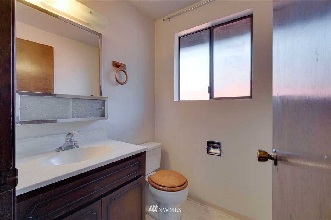 709 Sheridan Road Bremerton, WA 98310 - Photo 12 of 19 a bathroom with a sink toilet and a mirror