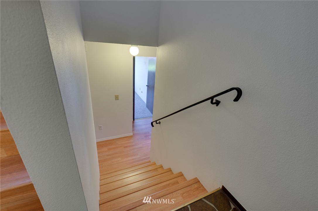 709 Sheridan Road Bremerton, WA 98310 - Photo 13 of 19 a view of a hallway with wooden floor and staircase