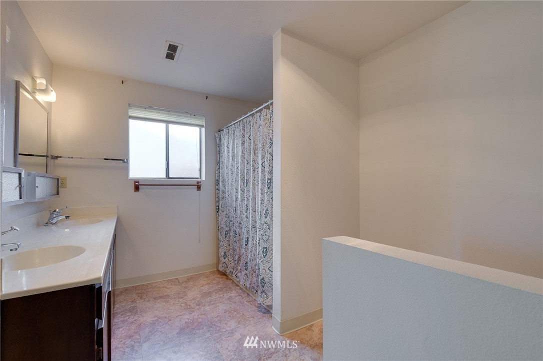 709 Sheridan Road Bremerton, WA 98310 - Photo 17 of 19 a bathroom with a sink a toilet and a mirror