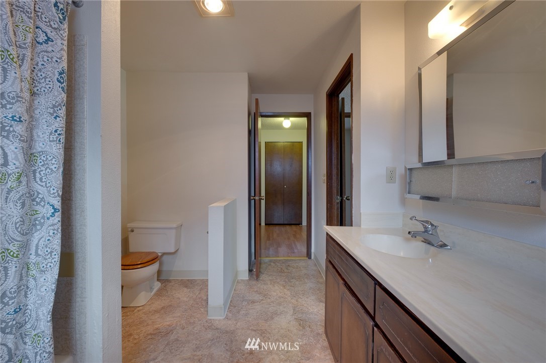 709 Sheridan Road Bremerton, WA 98310 - Photo 18 of 19 a bathroom with a sink a toilet and shower