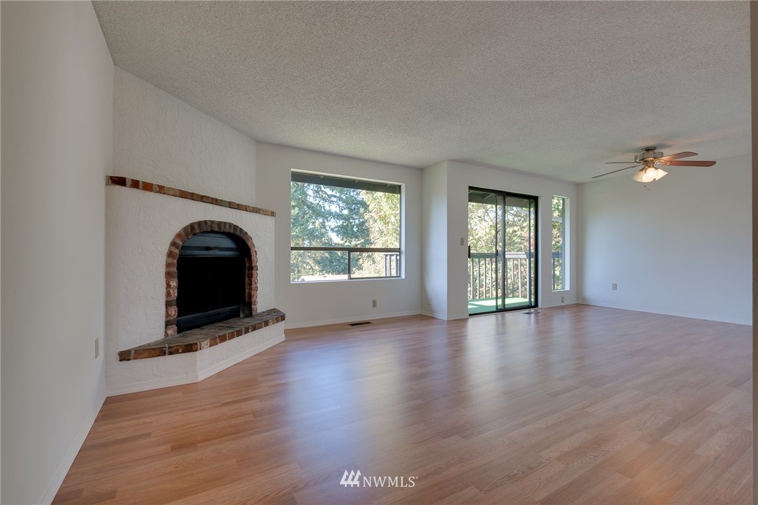 709 Sheridan Road Bremerton, WA 98310 - Photo 5 of 19 a view of a livingroom with wooden floor and a fireplace