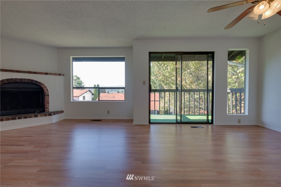 709 Sheridan Road Bremerton, WA 98310 - Photo 6 of 19 a view of an empty room with wooden floor and a window