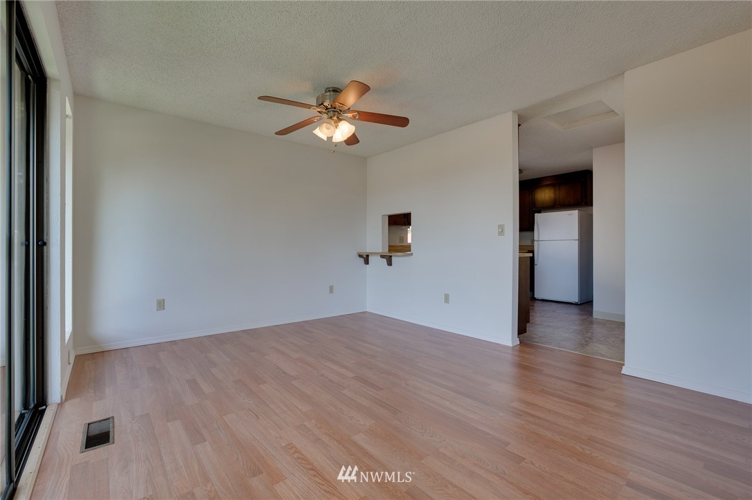 709 Sheridan Road Bremerton, WA 98310 - Photo 7 of 19 wooden floor in an empty room with a window