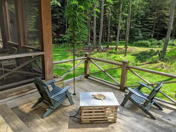 a view of a chairs and table in the patio with a backyard
