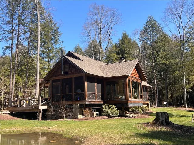 a front view of a house with a yard table and chairs